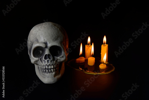 Skulls with Candle flame at night on black background.Halloween day concept.