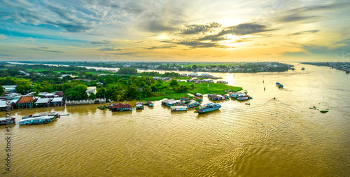 Floating village along Hau river over Vietnam border area, aerial view. The river basin contains a lot of seafood and alluvium for agriculture and economic development in the Mekong Delta photo