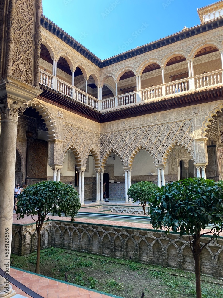 Palace of Alcazar, famous Andalusian architecture, an old Arab place in Seville, Spain. ornamented arch and column. High quality photo