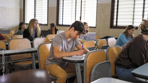 Young people studying inside university classroom - School education concept