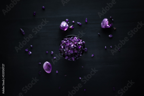 amethyst chips macro detail black background. close-up polished semi-precious gemstone top view copy space.