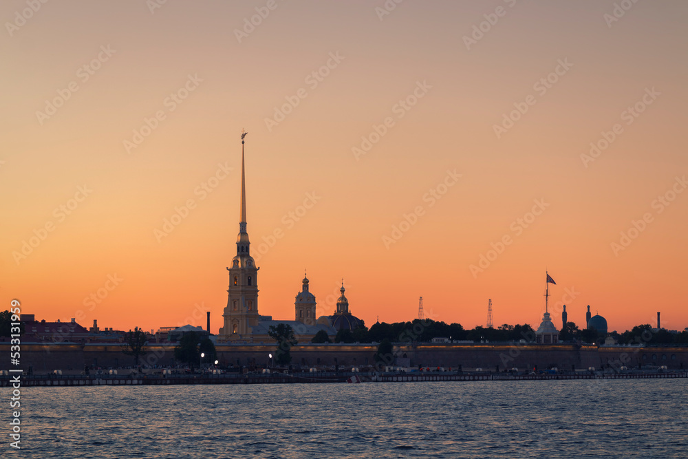 Water surface in front of the Peter and Paul Fortress against the sky in summer evening