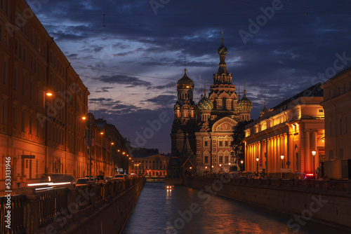 A river and an embankment in front of the Church of the Savior on Spilled Blood against the sky at summer night