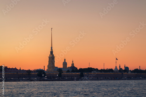 Water surface in front of the Peter and Paul Fortress against the sky in summer evening