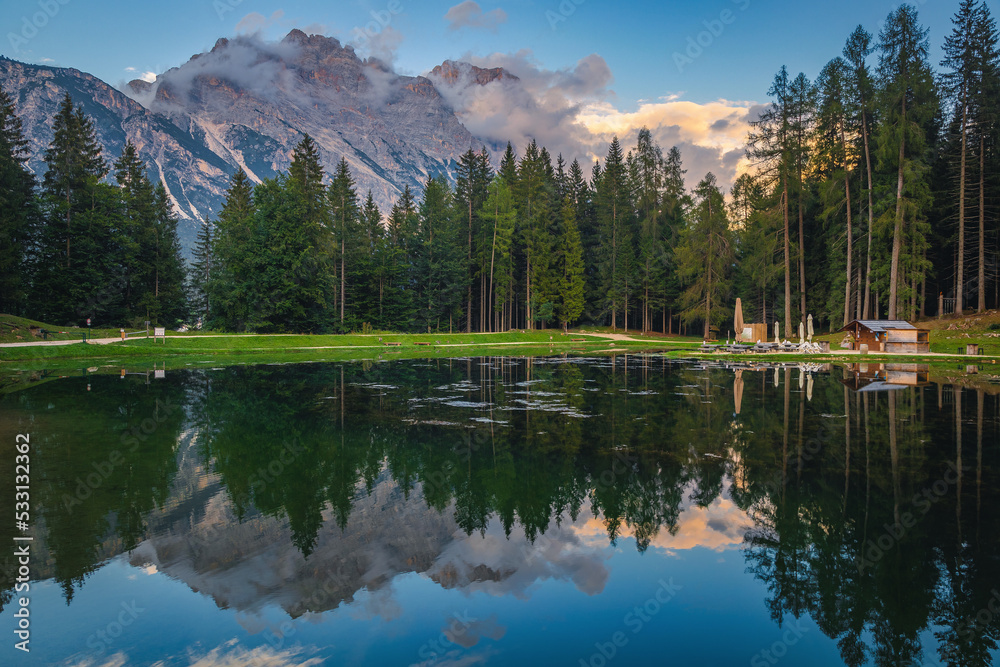 Beautiful lake Pianoze in the green pine forest, Dolomites, Italy