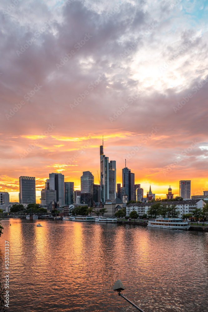 Sunset on the Mein river with a skyline in the background. Romantic city shot of Frankfurt, Hessen, Germany