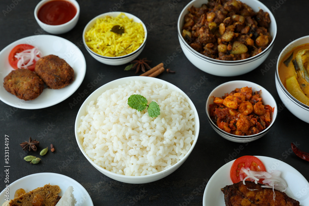 Rice and non vegetarian curry for Christmas special food in Kerala India. Indian pork fish beef prawns curry with white rice cutlet  appam.