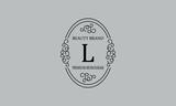 Premium monogram with the letter L. Frame with ornament. Luxury logo design with minimal modern font.