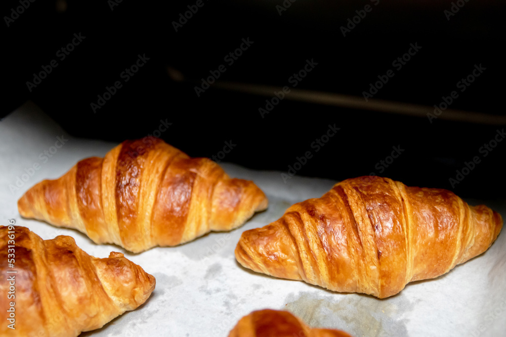 Croissant dough proofing on wooden tray with nature sunlight in a kitchen. Croissant dough proofing on wooden tray with nature sunlight in a kitchen.