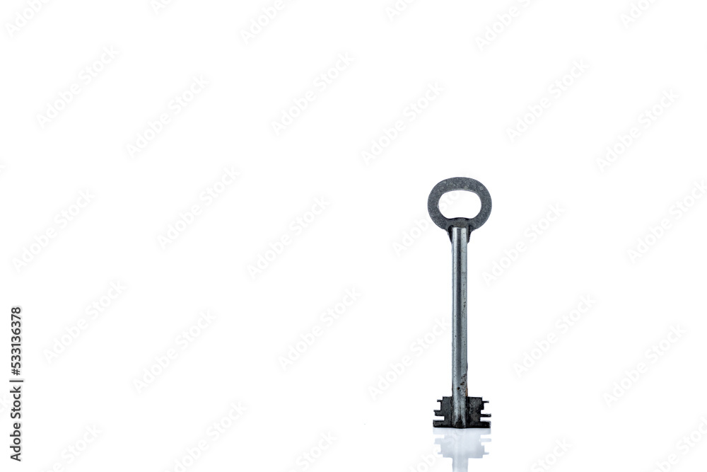 Old key isolated on white background. with reflection. front view with copy space Old key isolated on white background. with reflection. front view with copy space