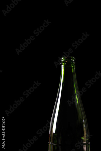 green glass bottle isolated on black background