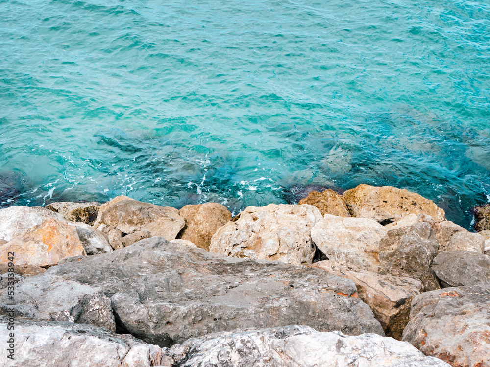 Blue sea and grey rocks. Photo from above Blue sea and grey rocks. Photo from above
