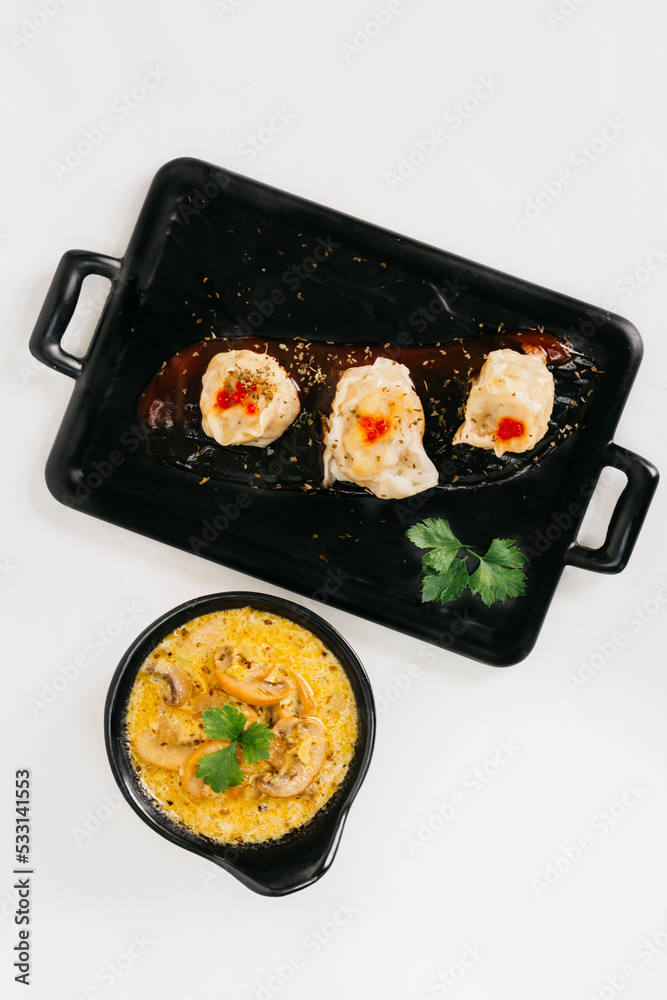 Steam dumplings with mushroom sauces on the plate