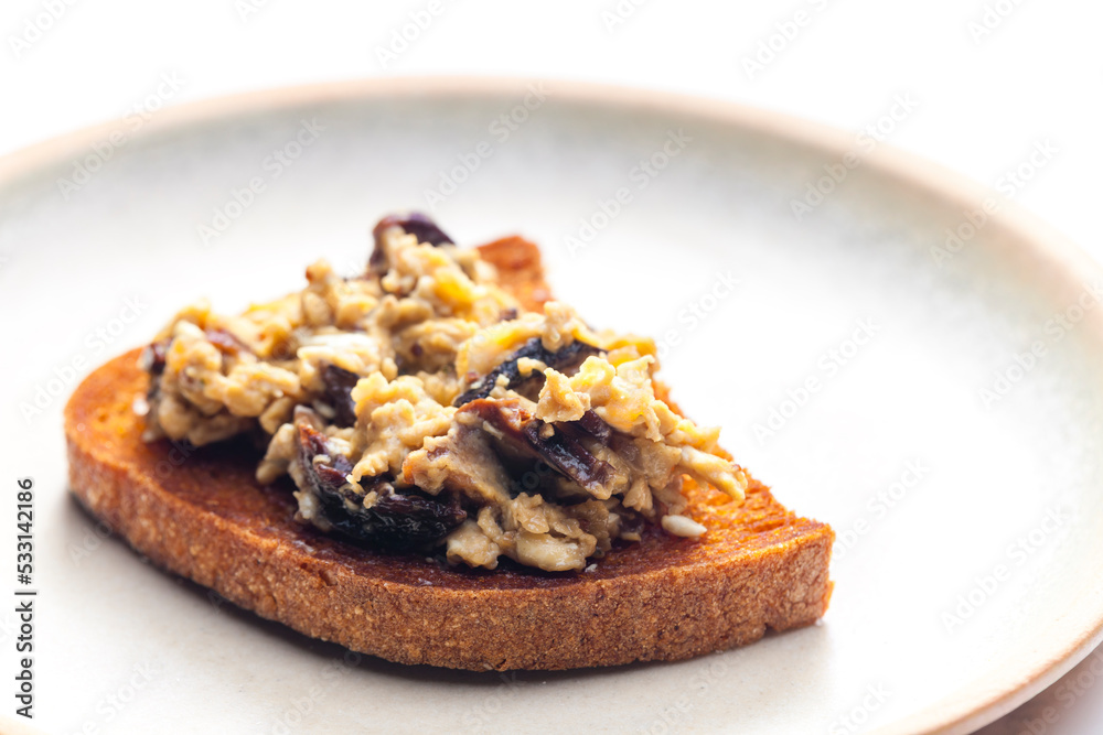 roasted bread served with scrambled eggs and mushrooms roasted bread served with scrambled eggs and mushrooms