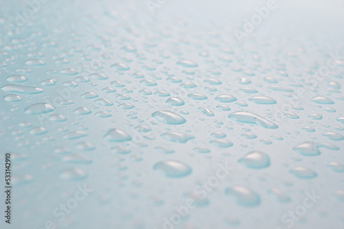 Close up of dropped water on a blue background. Freshness, raindrop