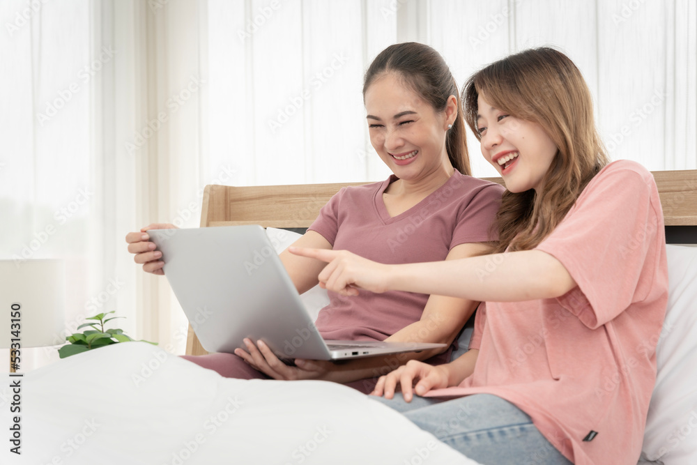Asian woman sitting at home working in the bedroom take notes of the meeting Record work with a notebook. Cheerful, fun at work. Asian woman sitting at home working in the bedroom take notes of the meeting Record work with a notebook. Cheerful, fun at work.