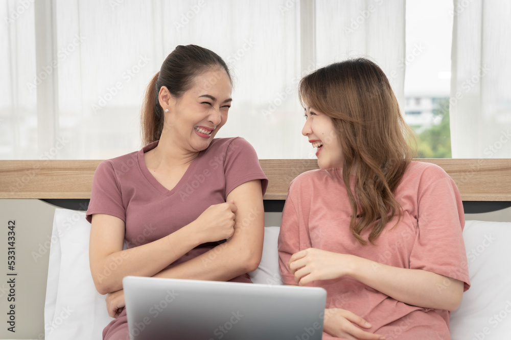 Asian woman sitting at home working in the bedroom take notes of the meeting Record work with a notebook. Cheerful, fun at work.