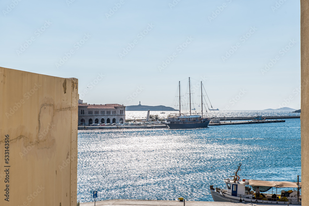 Window view of Syros port on a beautiful summer day, Cyclades, Greece