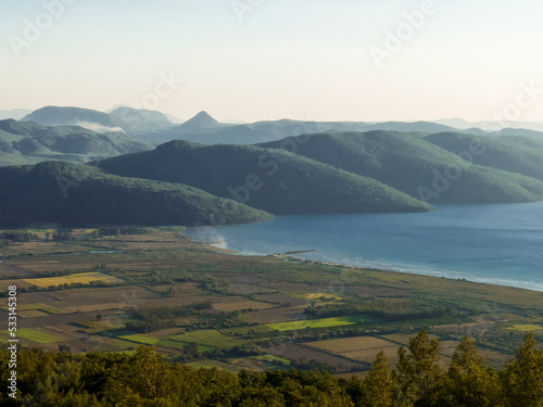 Beautiful landscape with sea mountains and rural fields.