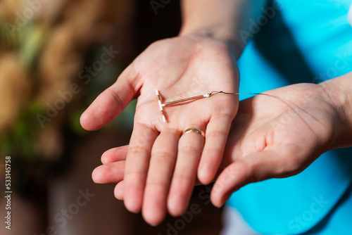 female contraceptive spiral in the hands of a nurse. device forbidding the birth of a child in a woman's hand. a medical device that prevents the fertilization of an egg. anticonception for girls