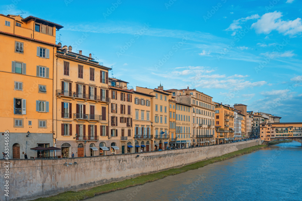 The Ponte Vecchio, Old Bridge, is a Medieval stone closed-spandrel segmental arch bridge over the Arno River, with shops built along it; as jewelers, art dealers and souvenir sellers. Italy, 2019