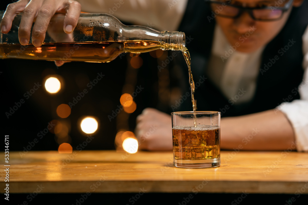 Barman pouring whiskey whiskey glass 