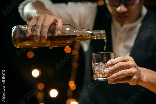 Barman pouring whiskey whiskey glass beautiful night