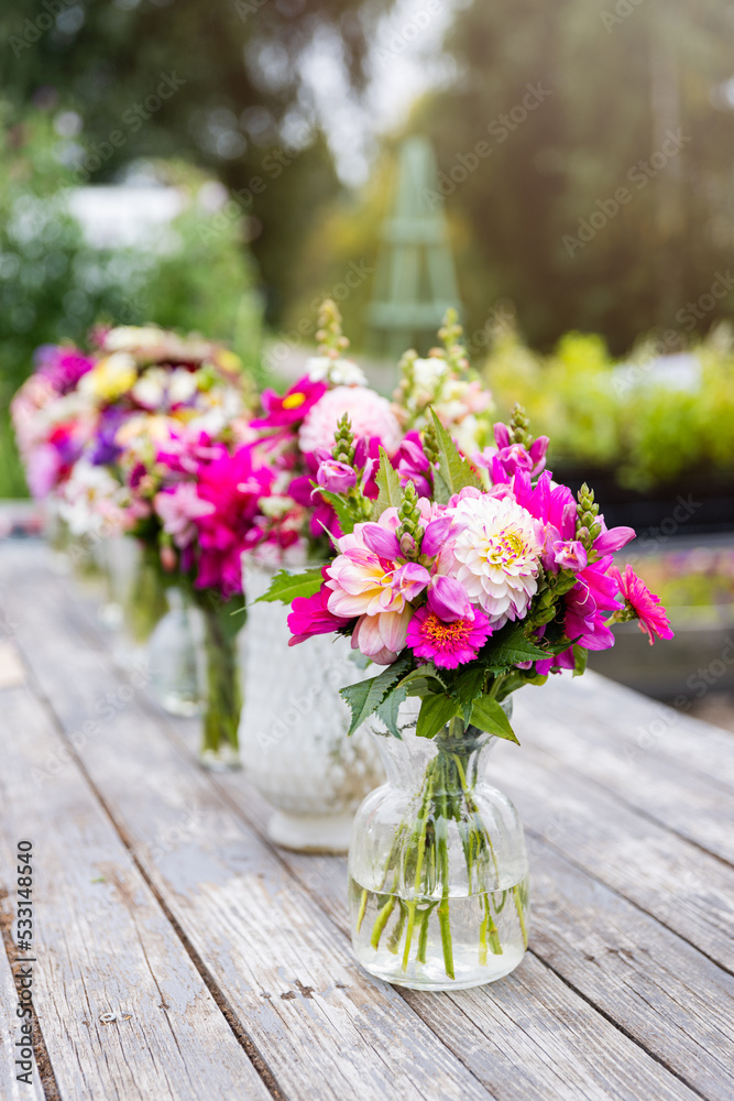 Dahlia bouquets outdoors on a wooden table Dahlia bouquets outdoors on a wooden table