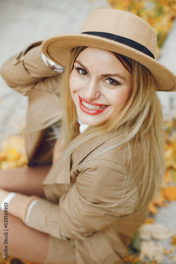 Portrait of a young blonde girl in a beige hat outdoors on autumn Portrait of a young blonde girl in a beige hat outdoors on autumn