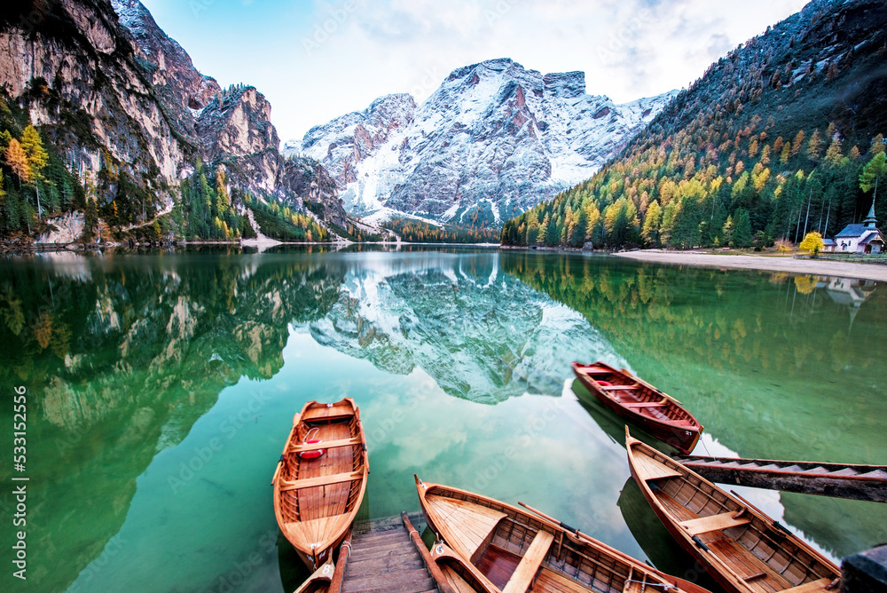 Magical autumn landscape with boats on the lake on Fanes-Sennes-Braies natural park in the Dolomites in South Tyrol, Alps, Italy. (mental vacation, holiday, inner peace, harmony - concept)