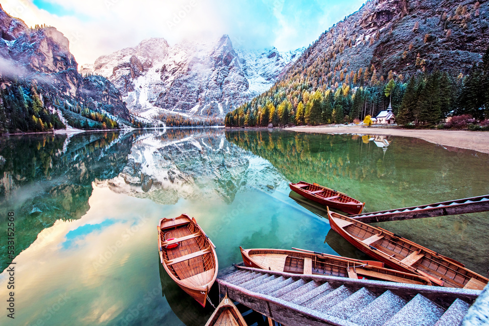 Magical autumn landscape with boats on the lake on Fanes-Sennes-Braies natural park in the Dolomites in South Tyrol, Alps, Italy. (mental vacation, holiday, inner peace, harmony - concept)