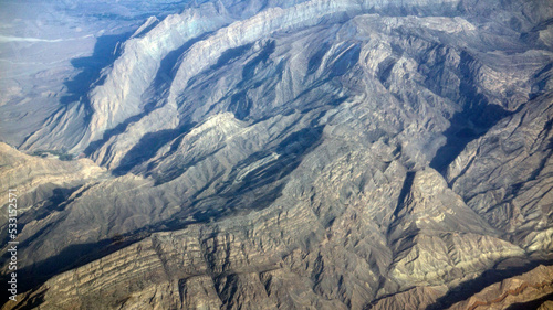 A fantastic landscape opening from the window of the plane. Mountains from a bird's-eye view.