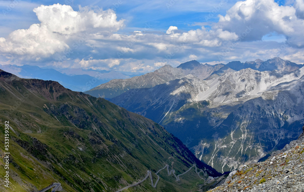 mountain panorama view with forest on the slopes of the mountains. Dramatic, high and beautiful Alps. Beautiful sky over the mountains. The rays of the sun and the road. Travel and challenge mountain panorama view with forest on the slopes of the mountains. Dramatic, high and beautiful Alps. Beautiful sky over the mountains. The rays of the sun and the road. Travel and challenge