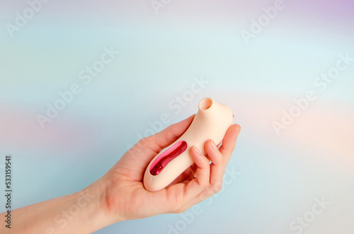 pink vacuum wave vibrator for clitoral stimulation in an elegant female hand. Sex toy for women