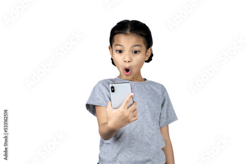 A little Asian girl in her right hand holds a mobile phone. and taking selfie with a mobile phone isolated on white background with clipping path.