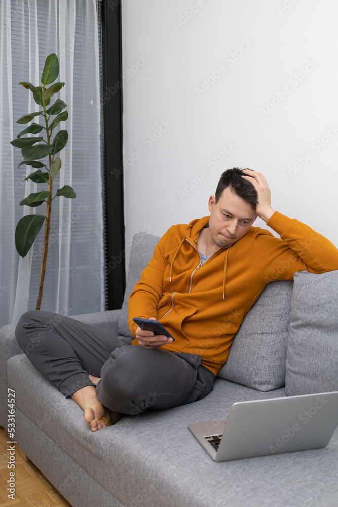 young man watching at mobile phone playing game