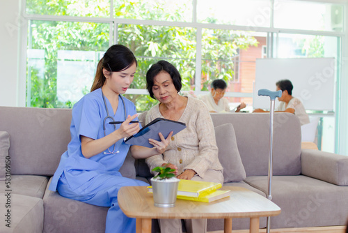 Nursing Home Care concept. The staff explained to the elderly who signed a medical treatment contract, a nursing home service agreement form.