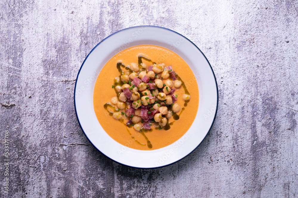Salmorejo with chickpeas and ham. Typical Spanish cold soup recipe made with tomatoes and vegetables. Traditional tapas from the south of Spain. Salmorejo with chickpeas and ham. Typical Spanish cold soup recipe made with tomatoes and vegetables. Traditional tapas from the south of Spain.