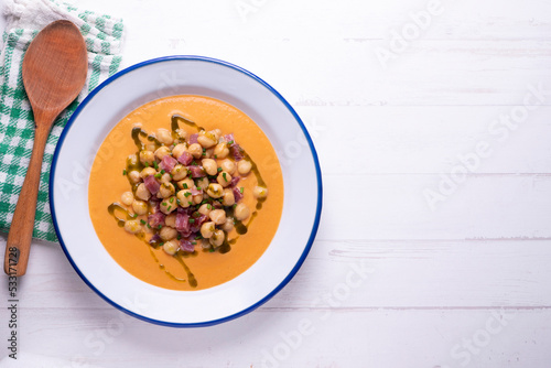 Salmorejo with chickpeas and ham. Typical Spanish cold soup recipe made with tomatoes and vegetables. Traditional tapas from the south of Spain.