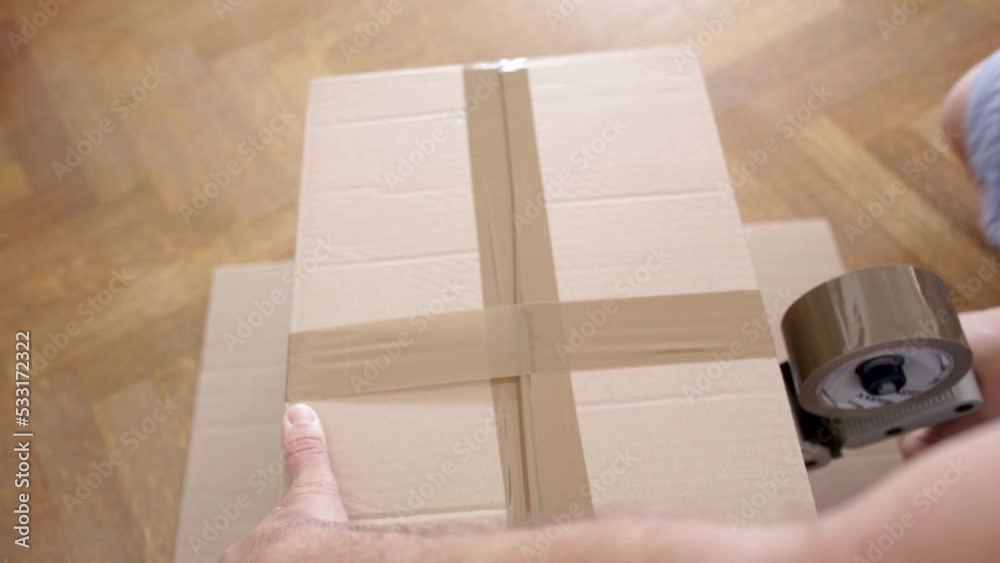 moving house - close up of a hand holding a cardboard box - Video
