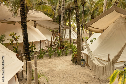 Beautiful Mexican beach tent hotel or hostel. Tents in the jungle decorated with plants and flowers  Tulum  Mexico