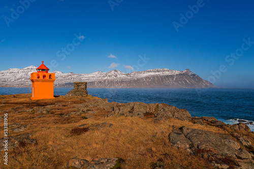 Djupivogur Lighthouse  is located on the southeast coast of Iceland, on a rocky point on the west side of the port of Djúpivogur. photo