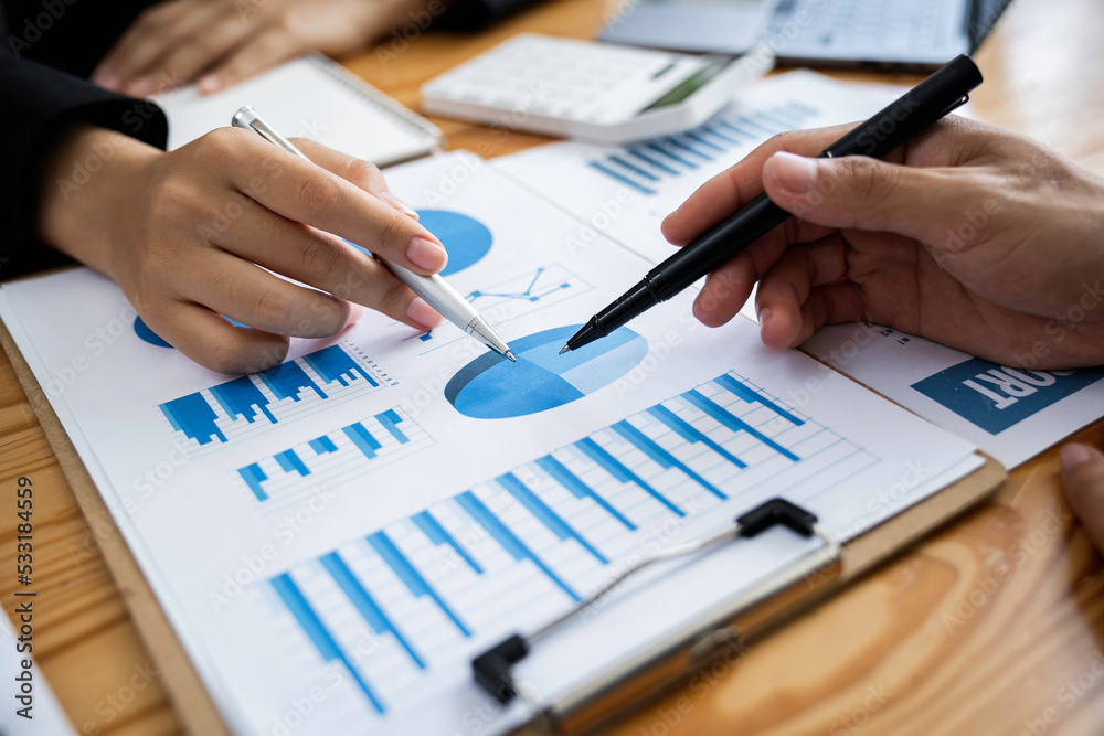 Business Asian people are meeting to analyze data figures to plan business strategy with financial paperwork. Business discussing, accounting bookkeeping concept Business Asian people are meeting to analyze data figures to plan business strategy with financial paperwork. Business discussing, accounting bookkeeping concept