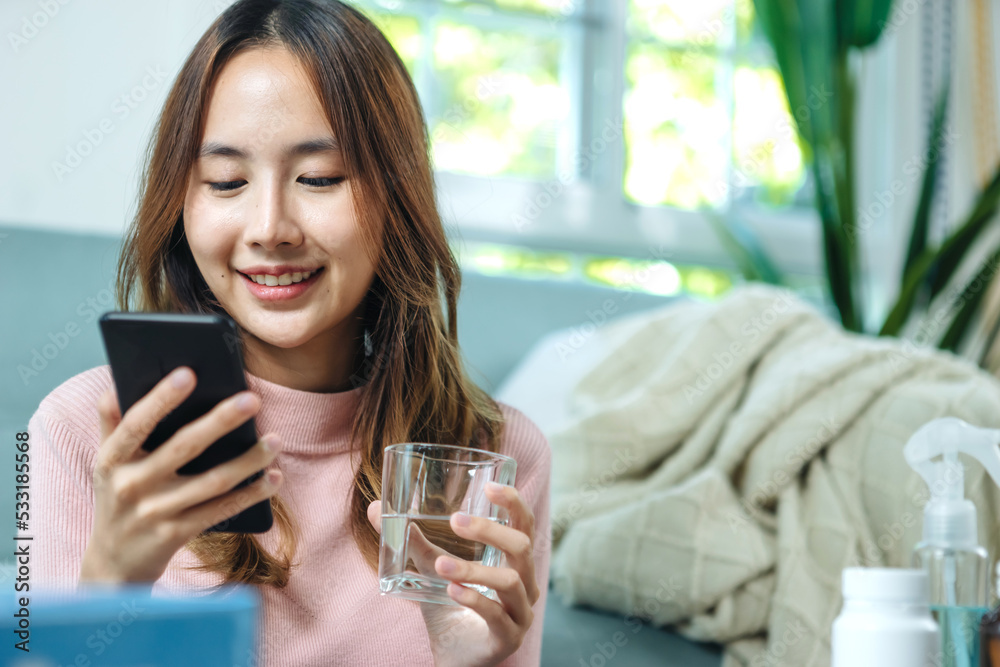 Young asian women checking pills while ordering online medicines on mobile phone at home - concept of E pharmacy, technology and healthcare Young asian women checking pills while ordering online medicines on mobile phone at home - concept of E pharmacy, technology and healthcare