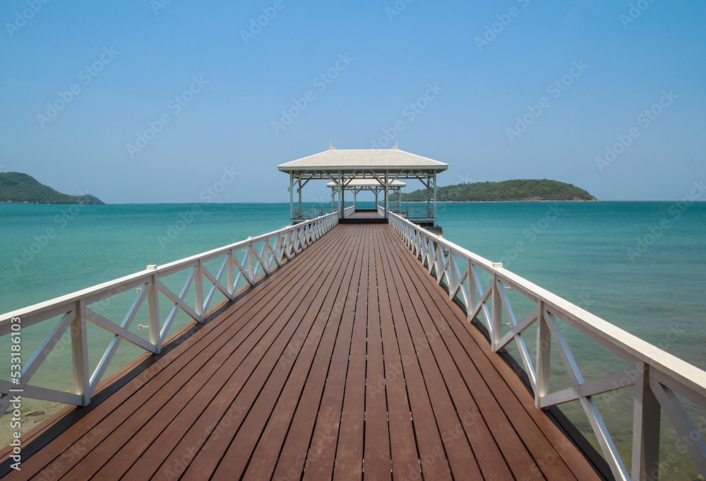 The classic wooden bridge go to white pavilion on the sea in Sri Chang Island ,Thailand