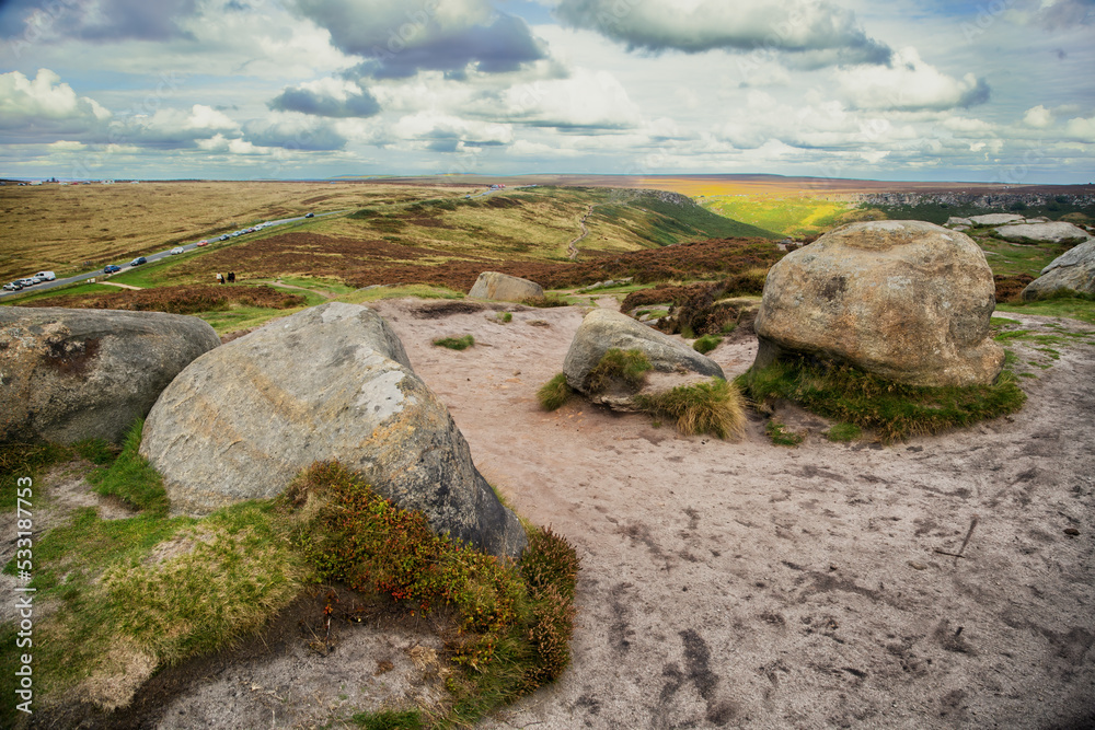 Hill walking on the gritstone outcrops on Higger Tor in the De rbyshire Peak Distrct