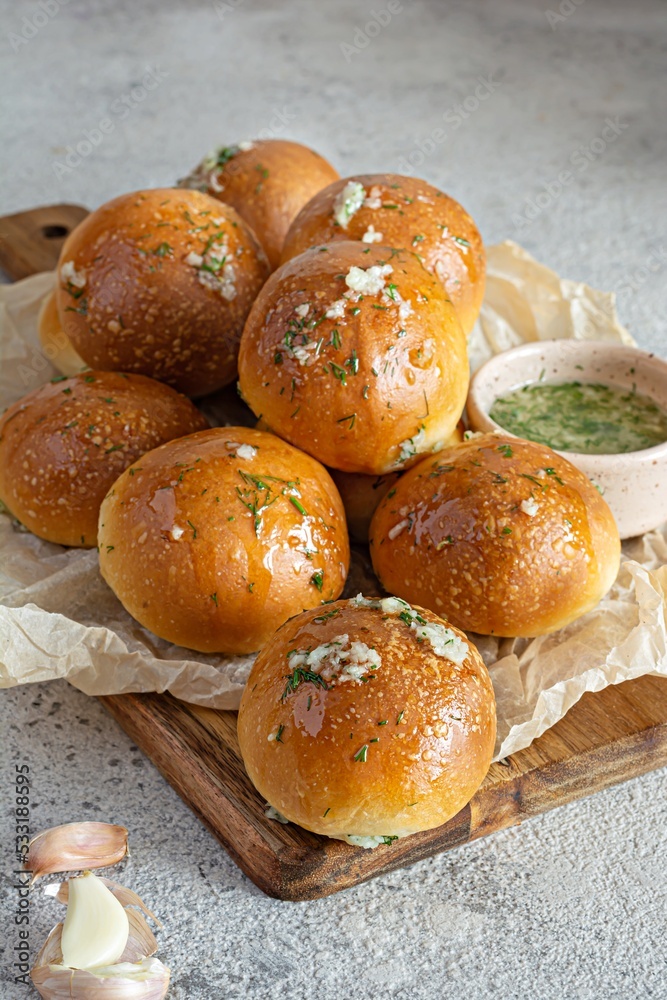 Freshly baked buns (pampushki) with garlic and dill for the first course (soup) on a baking tray. National Ukrainian dish, food. Selective focus. Freshly baked buns (pampushki) with garlic and dill for the first course (soup) on a baking tray. National Ukrainian dish, food. Selective focus.