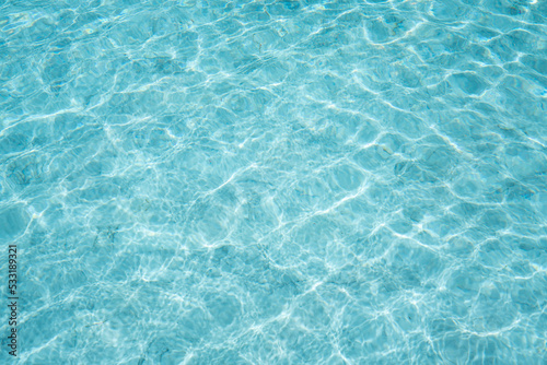 surface of blue and bright water in swimming pool