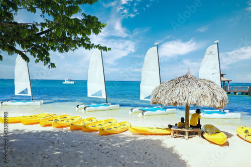 Jamaican people renting out boats on a beautiful caribbean beach, Jamaica