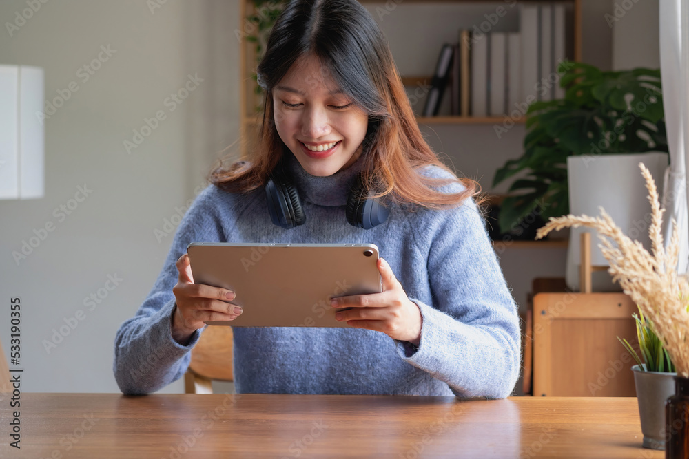 relax, de-stress, holiday, happy, Asian woman relaxing at home listening to music from smartphone and laptop happily. relax, de-stress, holiday, happy, Asian woman relaxing at home listening to music from smartphone and laptop happily.